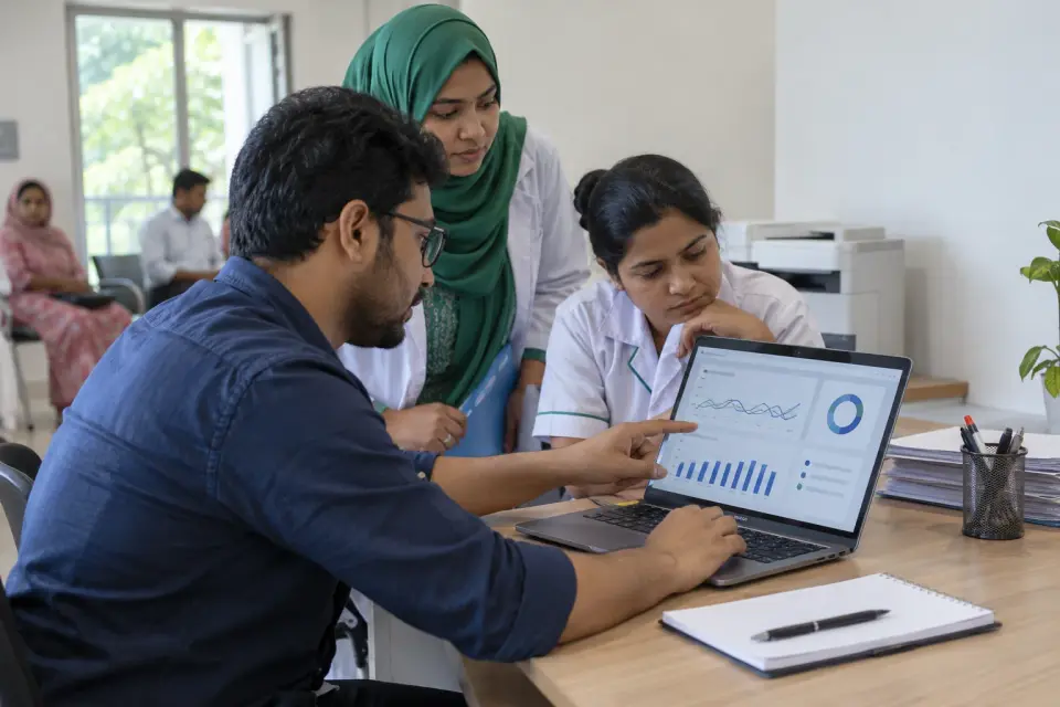 Clinic team reviewing report delivery records on a laptop Clinic team reviewing report delivery records on a laptop