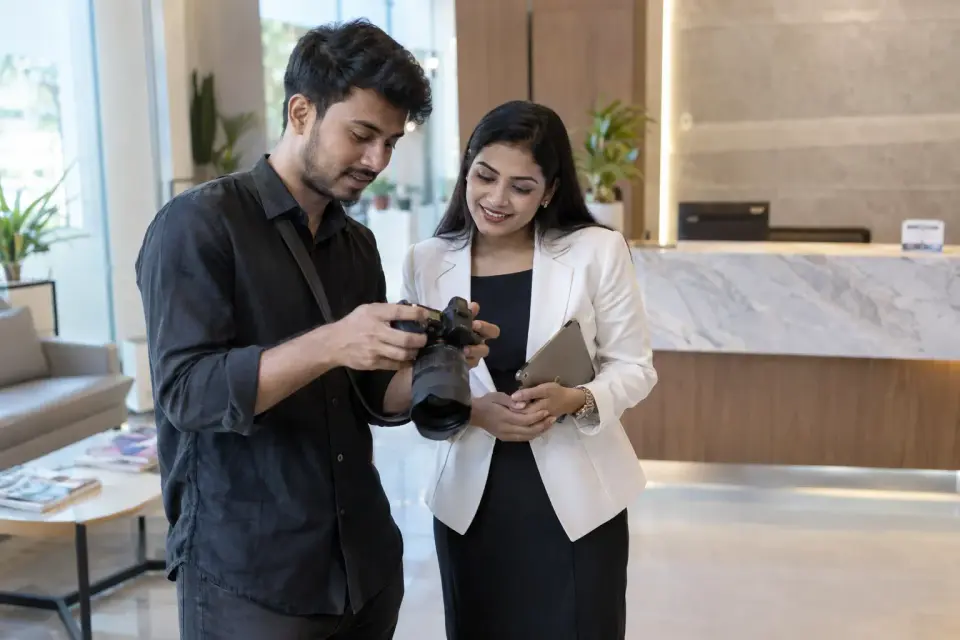 A content creator in a real clinic reception selects photographs of the public area with the clinic manager. A content creator in a real clinic reception selects photographs of the public area with the clinic manager.